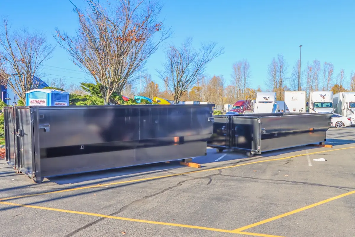 Professional dumpster rental service with roll-off container on residential driveway in Hermitage